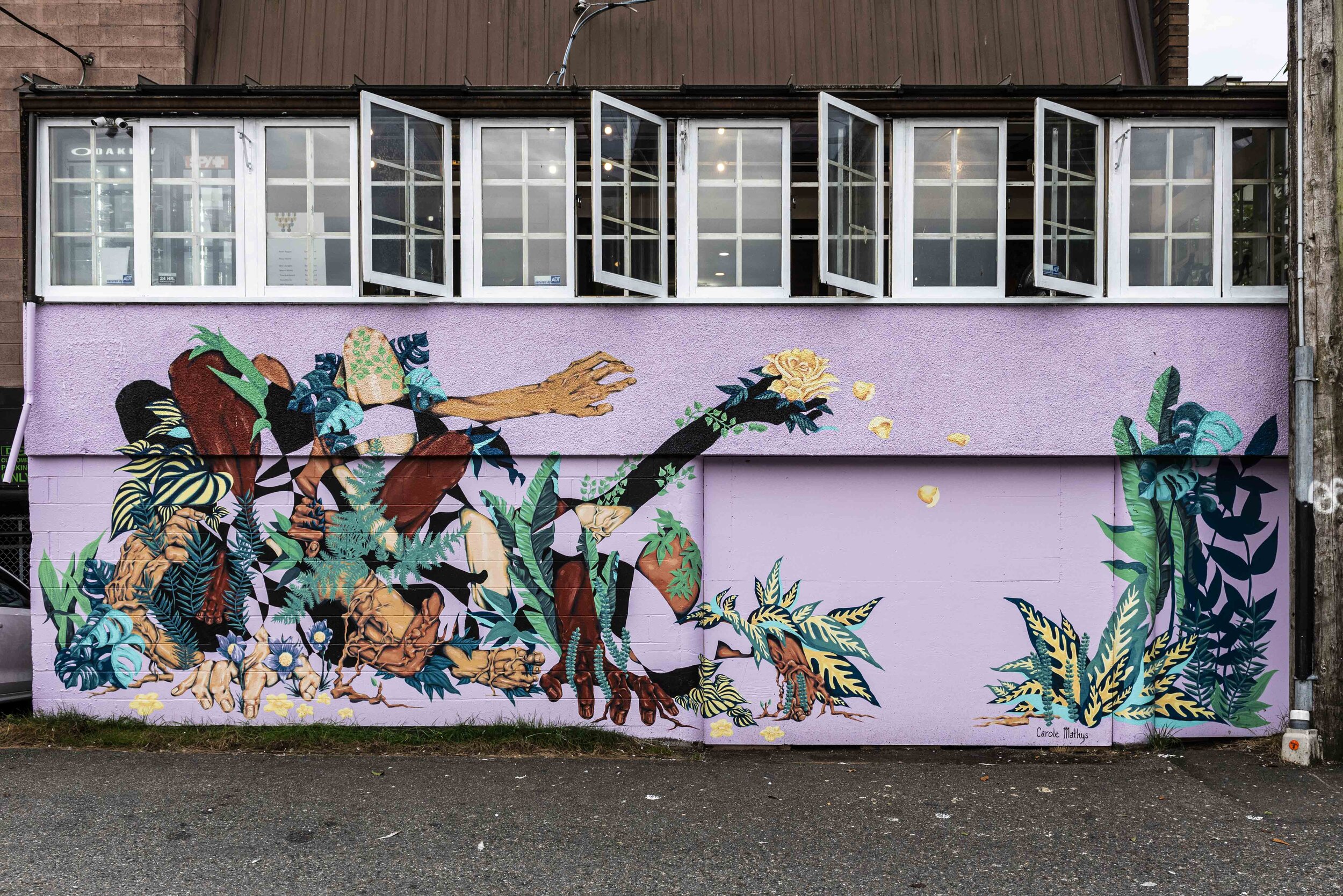 Mural depicting plants and foliage growing out of hands and limbs.