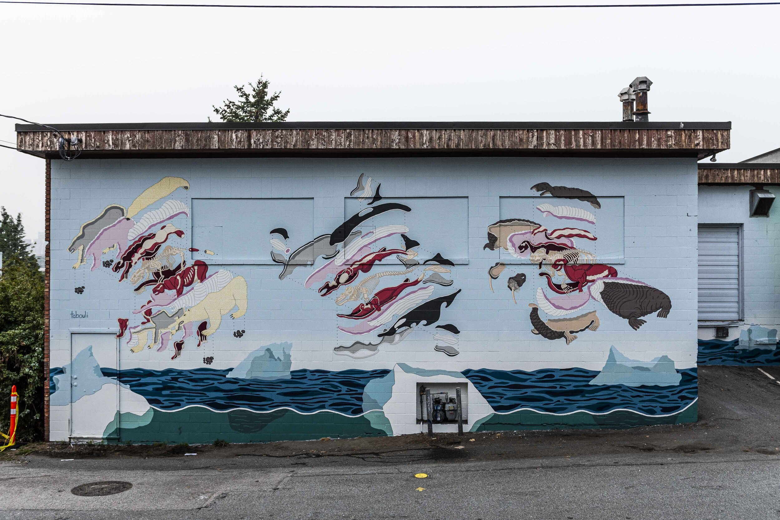 Mural of arctic ocean and three animals painted in exploded isometric projection.