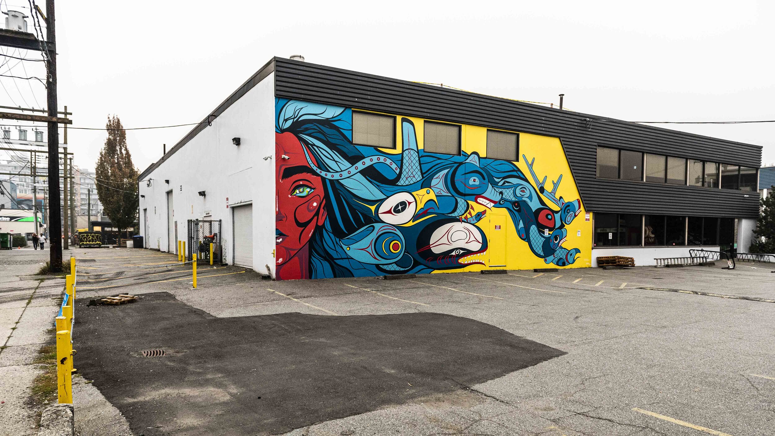 Mural of woman with hair turning into different animals as it blows in the wind.
