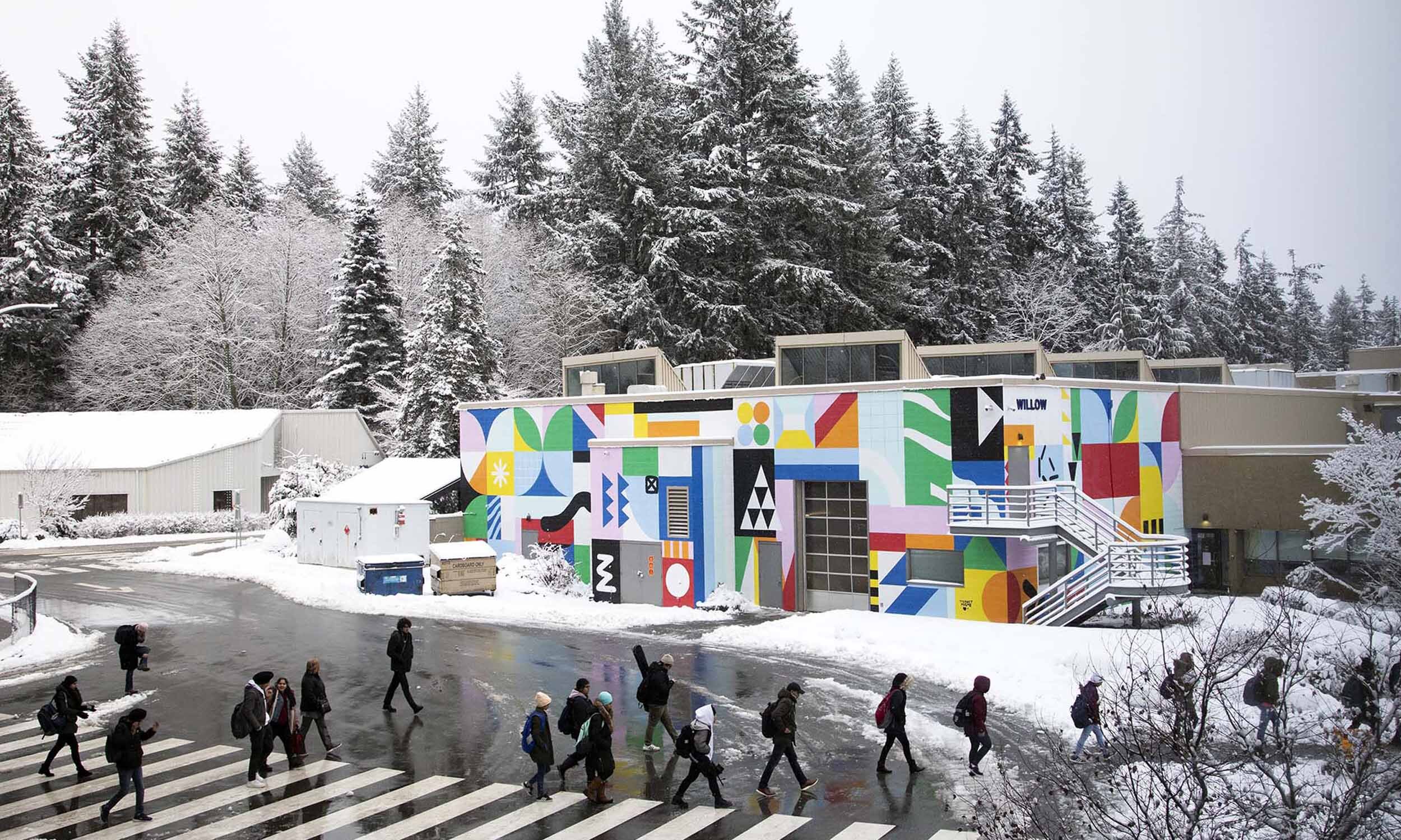 Multicoloured abstract colourful mural (by artist Tierney Milne) against a white snowy background at UBC, Vancouver.