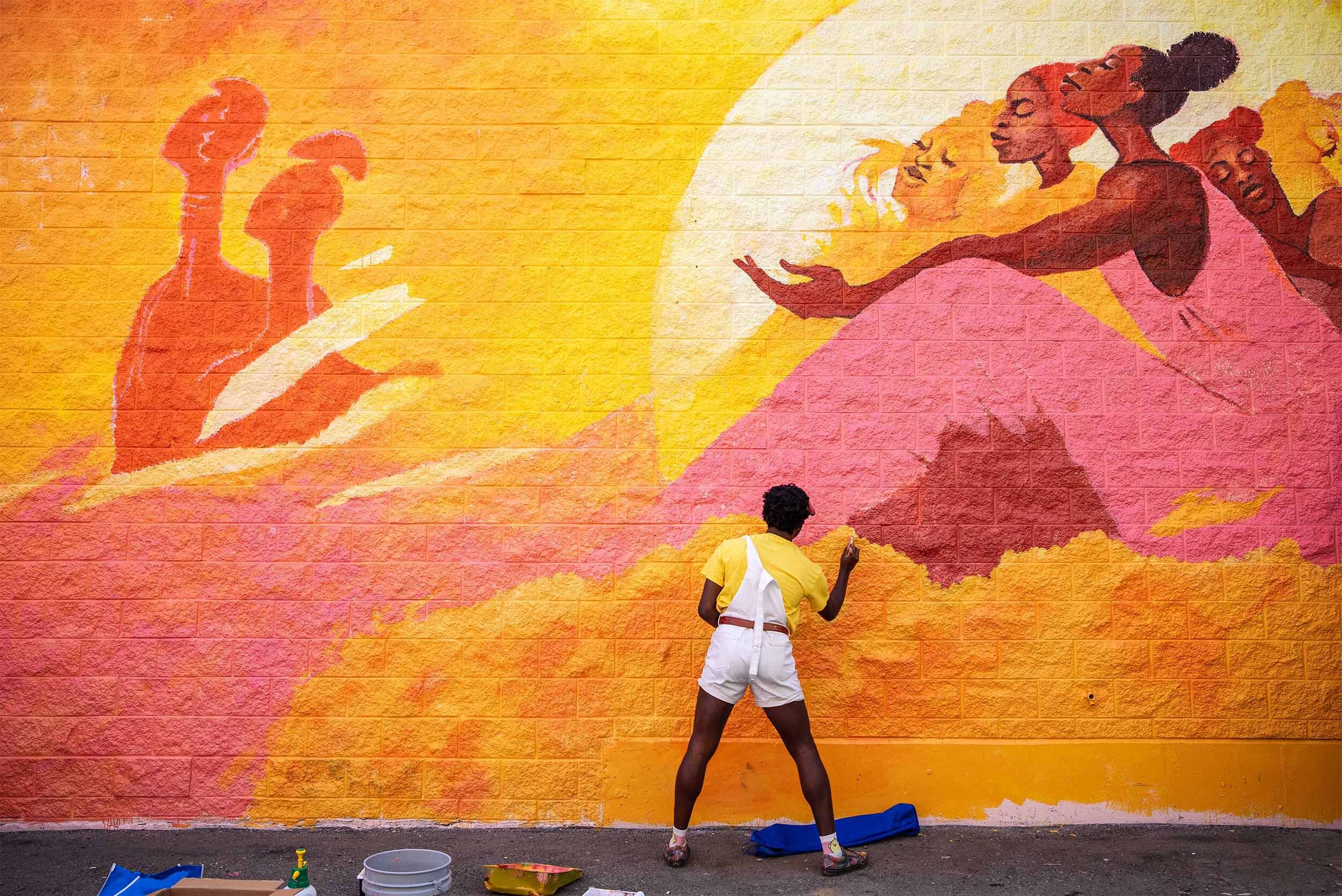 Local Artist Odera Igbokwe painting art mural for Vancouver Mural Festival.jpg