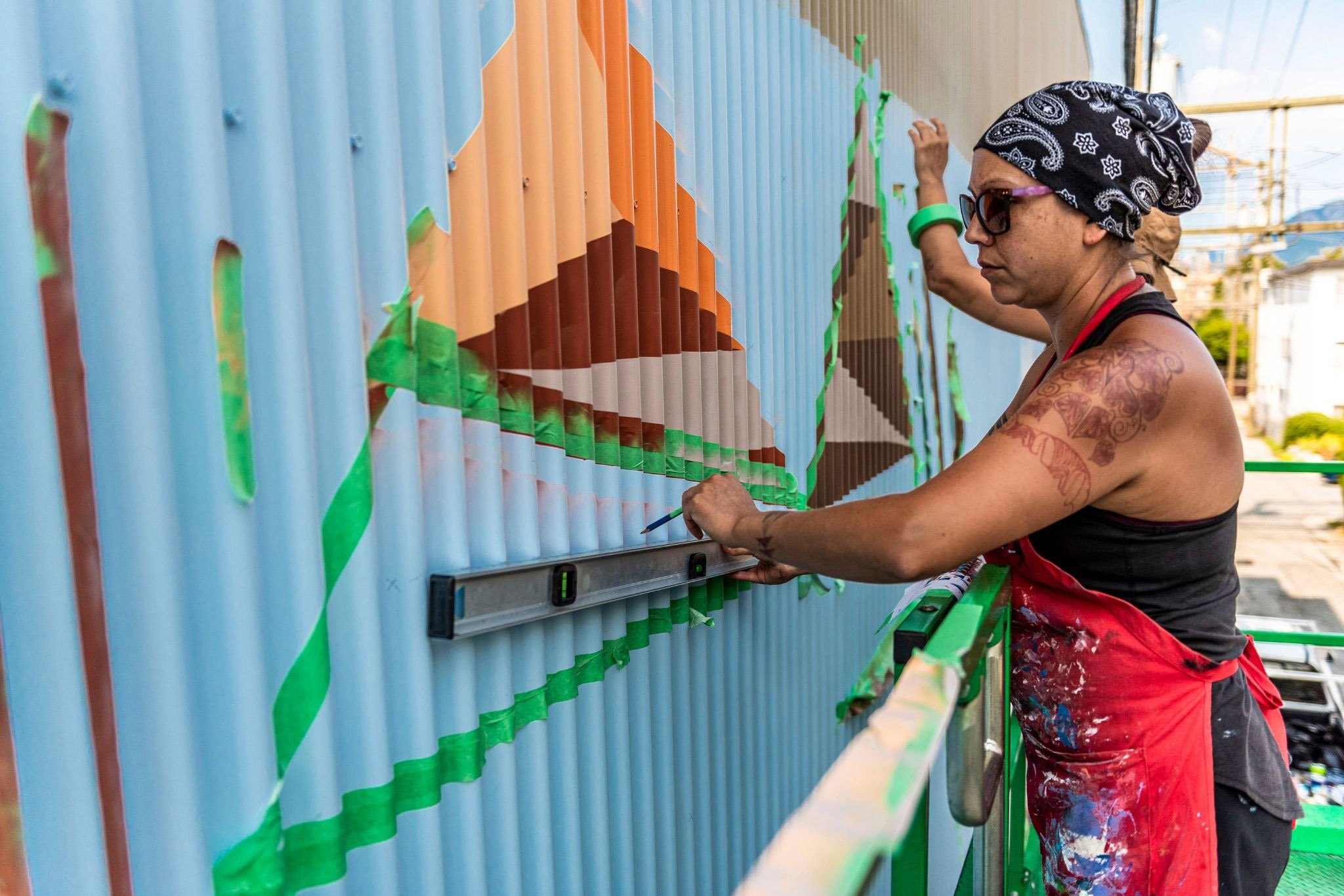 Local Indigenous Artist Carrielynn Victor painting mural for Vancouver Mural Festival VMF
