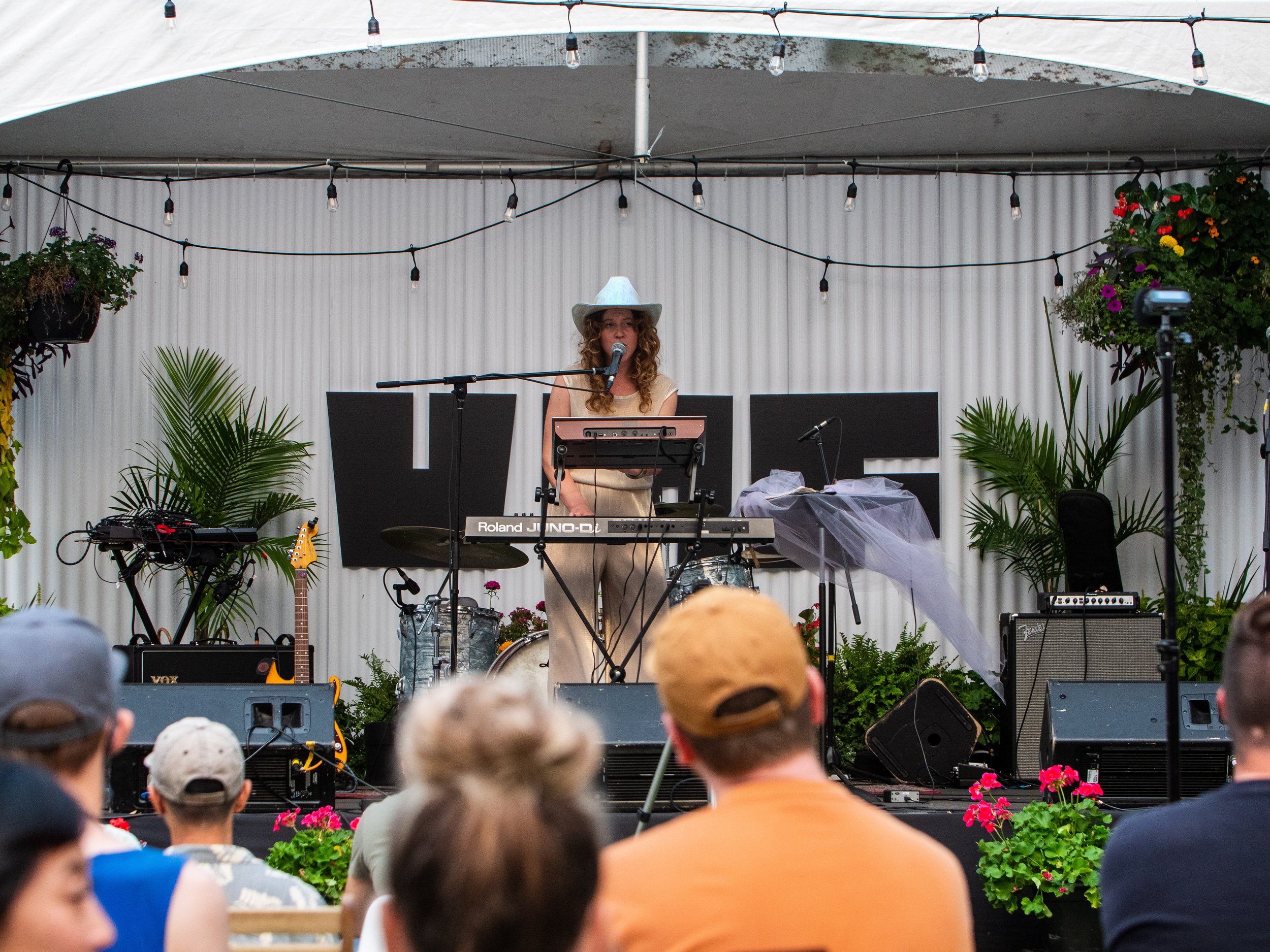 VMF - Artist playing keyboard on stage with audience members watching at Vancouver Mural Festival