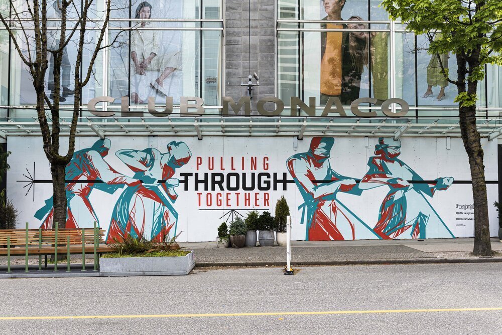 Mural in Downtown Vancouver of figures pulling rope with tagline "pulling through together"
