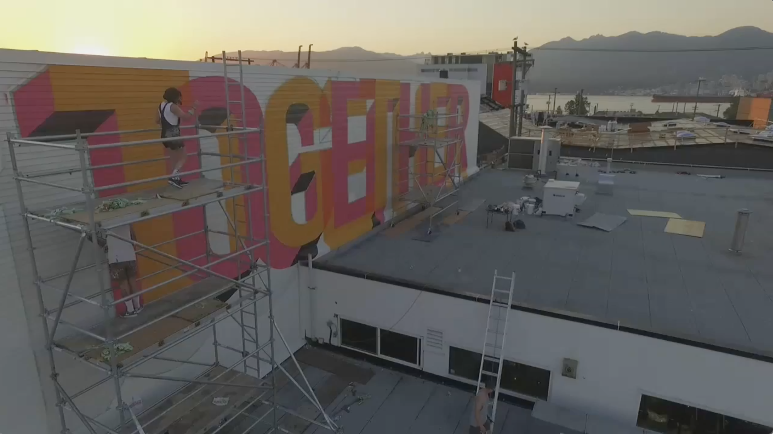 Mural Artists painting Benjamin Johnston's typographic %22Together%22 mural in Strathcona for Vancouver Mural Festival.png